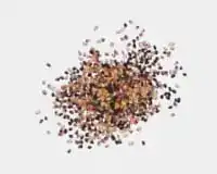 Loose cluster of brown granules scattered in a circular shape on a light background.